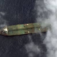 This handout image obtained Saturday courtesy of Satellite image &#169;2019 Maxar Technologies, reportedly shows the oil tanker Adrian Darya 1 near the port city of Tartus, Syria, on Friday. The U.S. blacklisted the tanker following repeated warnings over its valuable oil cargo. | SATELLITE IMAGE ©2019 MAXAR TECHNOLOGIES / VIA AFP-JIJI