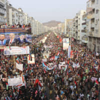 Supporters of southern separatists gather with the flags of south Yemen and the United Arab Emirates during a rally to show support for the UAE amid a standoff with the internationally recognized government, in Aden Thursday. Yemeni officials say Saudi Arabia is pushing for a settlement between the internationally recognized government and southern separatists backed by the UAE. | AP