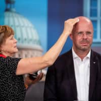 Andreas Kalbitz, top candidate of the far-right AfD (Alternative for Germany) party for state elections in Brandenburg, gets makeup prior the start of the TV show at the German channel ARD following the results of the exit polls during the state elections in Brandenburg on Sunday in Potsdam, eastern Germany. The far-right party surged strongly in elections in two eastern states, public television exit polls said, reflecting anger with Chancellor Angela Merkel\'s coalition government. | AFP-JIJI