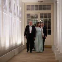 President Donald Trump and first lady Melania Trump walk with Australian Prime Minister Scott Morrison and his wife, Jenny Morrison (behind Trump) to a state dinner at the White House on Friday. | AP