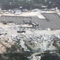 In this image courtesy of U.S. Coast Guard Air Station Clearwater, boats are strewn across a marina in the Bahamas on Monday as Hurricane Dorian makes its way across the Bahamas. | HO / US COAST GUARD / VIA AFP-JIJI