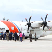 Prime Minister Hubert MInnis boards a U.S. Coast Guard plane en route to Abaco for a reconnaissance flight to survey damage caused by Hurricane Dorian, in Nassau Tuesday. | JOHN MARC NUTT / VIA REUTERS