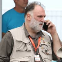 Jose Enrique, founder of World Kitchen Central, speaks on a cellphone at Odyssey Aviation in Nassau Tuesday. | JOHN MARC NUTT / VIA REUTERS