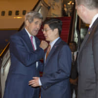 Chinese Ministry of Foreign Affairs Director General Cong Peiwu is seen with then-U.S. Secretary of State John Kerry at Beijing International Airport jn May 2015. | REUTERS