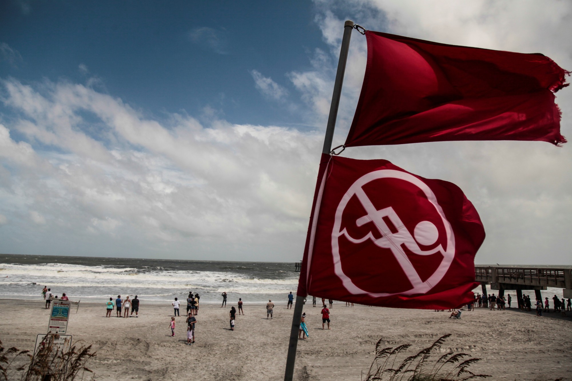 Red flags to indicate the ocean has a high tide and locals should not be swimming due to danger are seen at Jacksonville Beach before Hurricane Dorian, in Jacksonville, Florida, Tuesday. | REUTERS