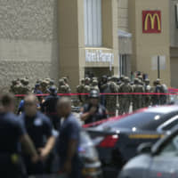 Several law enforcement agencies respond to an active shooter at a Walmart in El Paso, Texas, Aug. 3. The suspect in the mass shooting was indicted Thursday for capital murder. | MARK LAMBIE / THE EL PASO TIMES / VIA AP