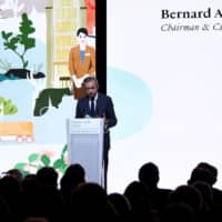 Chairman and Chief Executive of LVMH Bernard Arnault delivers a speech during the presentation of the group\'s environmental \"Life\" program (LVMH Initiatives For the Environment) on Wednesday at LVMH headquarters in Paris. | AFP-JIJI