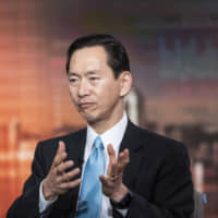 Bernard Chan, a top adviser to Hong Kong\'s government, speaks during a television interview in Hong Kong on June 17. | BLOOMBERG