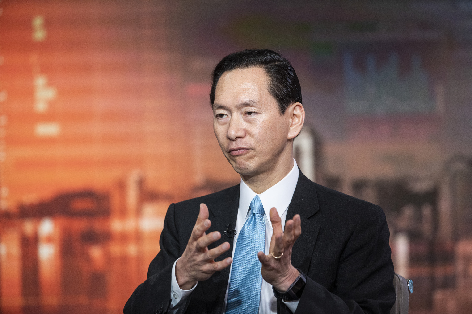 Bernard Chan, a top adviser to Hong Kong's government, speaks during a television interview in Hong Kong on June 17. | BLOOMBERG