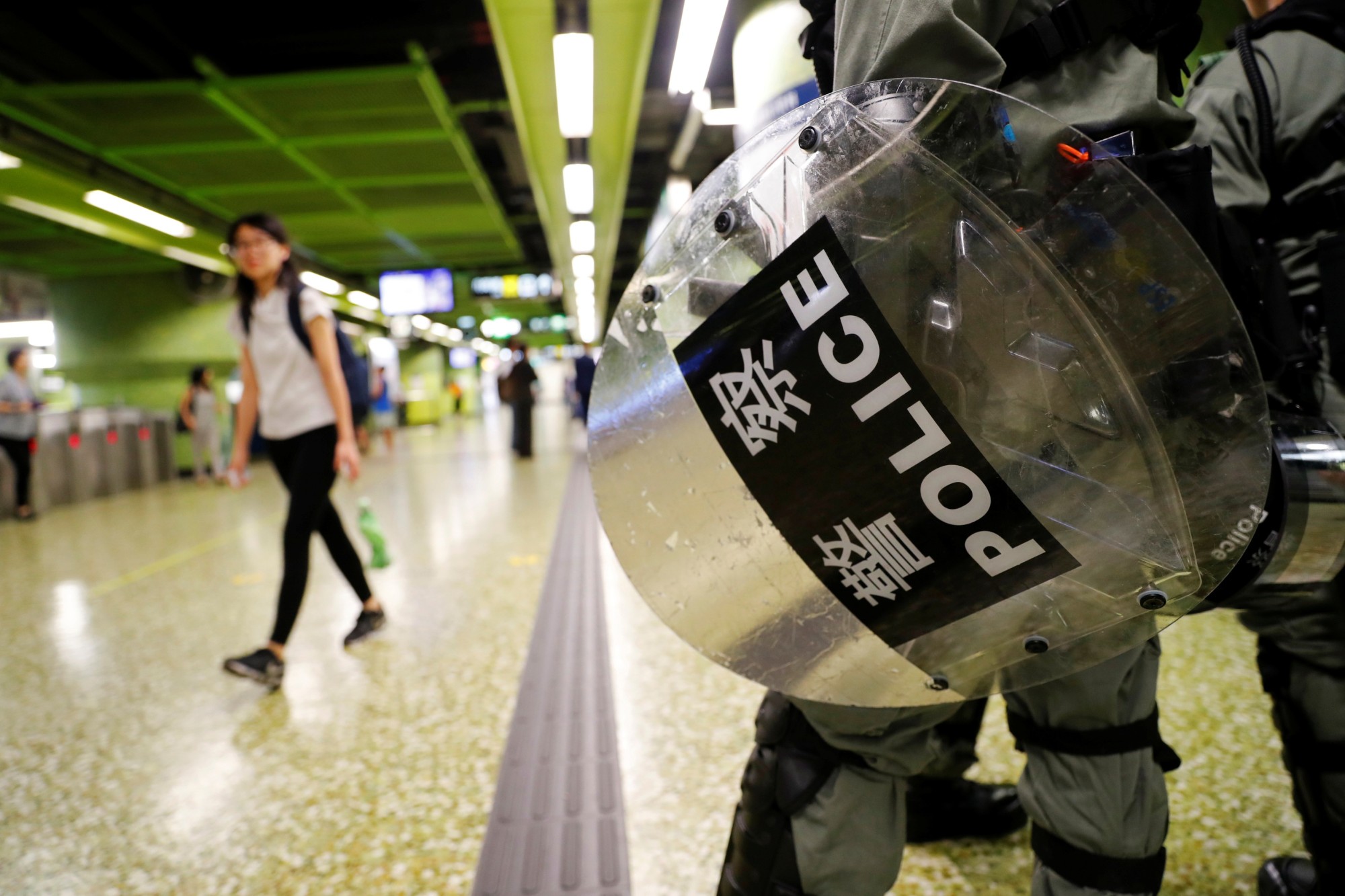A riot policeman holds his shield for protection at a Mass Transit Railway station in Hong Kong on Monday. | REUTERS