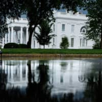 A person walks past the White House in Washington in May. Israel set up scanners to intercept cellphone communications in the area around the White House, according to a report Thursday was denied by the Jewish state. Politico reported that U.S. officials believe Israelis were most likely the ones who set up several so-called stingray scanners, which mimic cellphone towers to intercept nearby calls and text messages, that were discovered in downtown Washington in 2017. | AFP-JIJI