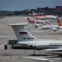 An Ilyushin Il-62 plane with Russian flag is seen at Simon Bolivar International Airport outside Caracas Wednesday. | REUTERS
