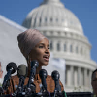 Rep. Ilhan Omar, flanked by Reps. Earl Blumenauer and Deb Haaland,  introduces the Zero Waste Act that would create a federal grant program to help local governments invest in waste reduction initiatives, at the Capitol in Washington. | AP