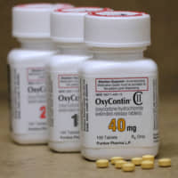 Bottles of prescription painkiller OxyContin, made by Purdue Pharma LP, are seen on a counter at a local pharmacy in Provo, Utah, in April 2017. | REUTERS