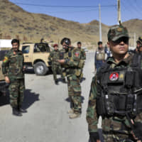 Afghan special forces stand guard at the site of a suicide car bomb explosion that killed at least four people, on the outskirts of Kabul Thursday. Taliban spokesman Zabihullah Mujahid has claimed responsibility for the bombing in a statement sent to the media. | AP