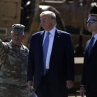 President Donald Trump tours a section of the southern border wall Wednesday in Otay Mesa, California, with the commanding general of the Army Corps of Engineers, Lt. Gen. Todd Semonite (left), acting commissioner of Customs and Border Protection Mark Morgan (right) and acting Homeland Secretary Kevin McAleenan. | AP