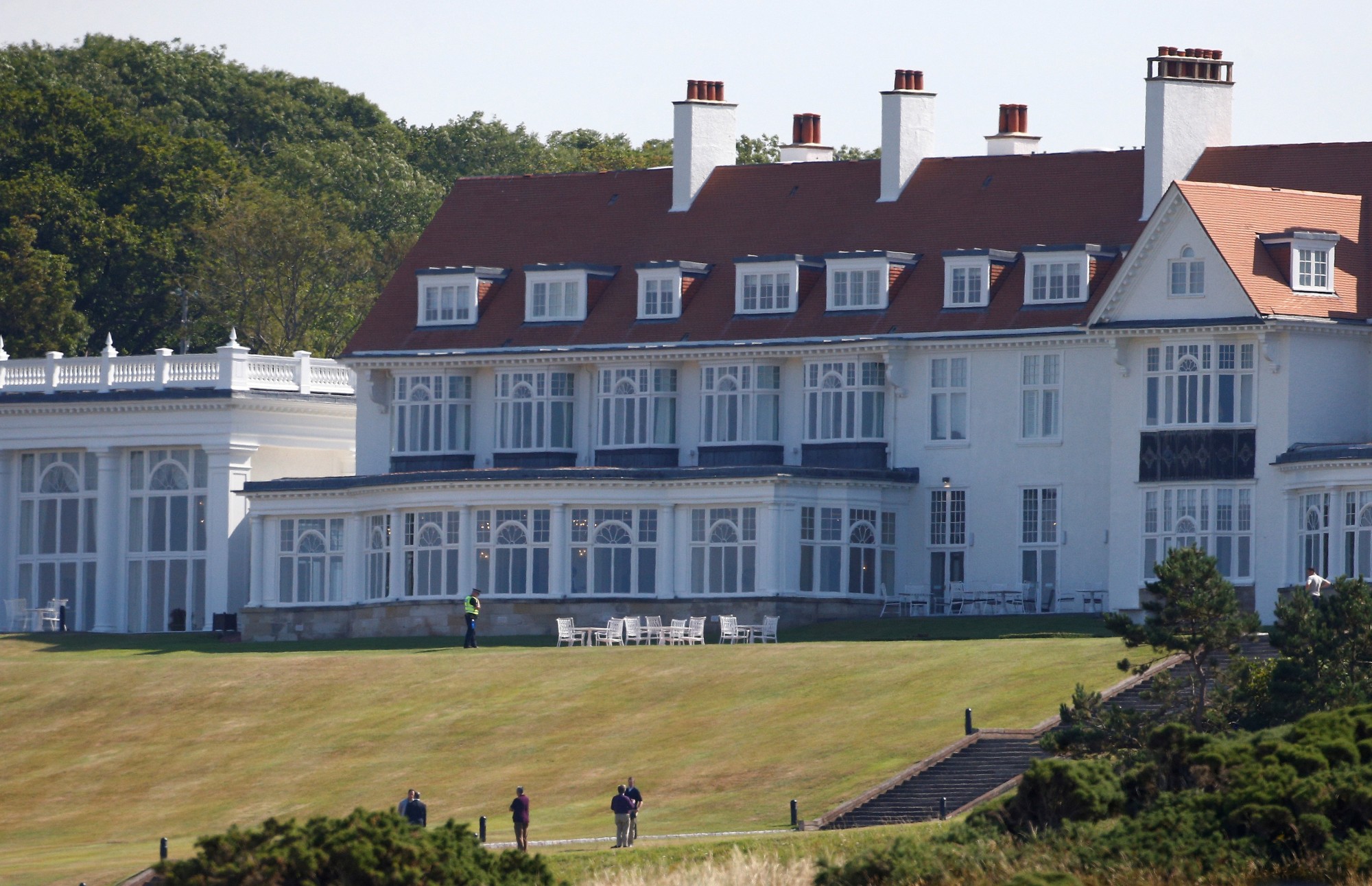 A police offer stands in the grounds of the golf resort owned by U.S. President Donald Trump, during Trump's stay at the resort, in Turnberry, Scotland, last year. | REUTERS