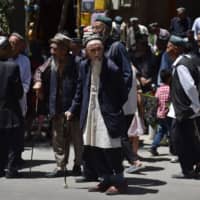 Uighurs leave a mosque after prayers in Hotan, in China\'s northwest Xinjiang region, on May 31. | AFP-JIJI