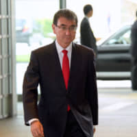 New Defense Minister Taro Kono arrives at the Prime Minister’s Office in Tokyo on Wednesday.  | SATOKO KAWASAKI
