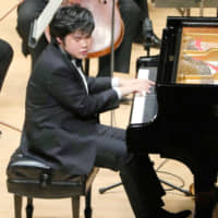 Pianist Nobuyuki Tsujii plays during a concert in Tokyo in November 2017. | POOL VIA / KYODO