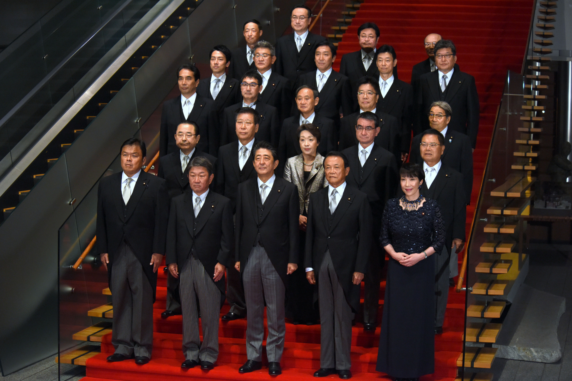 Prime Minister Shinzo Abe and members of his new Cabinet attend a photo session at the Prime Minister's Office in Tokyo on Wednesday evening after Abe reshuffled his team. | SATOKO KAWASAKI