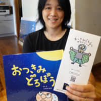 Kaori Nishihama shows her book and illustration on o-tsukimi dorobō (moon viewing thieves) in Nisshin, Aichi Prefecture. | CHUNICHI SHIMBUN