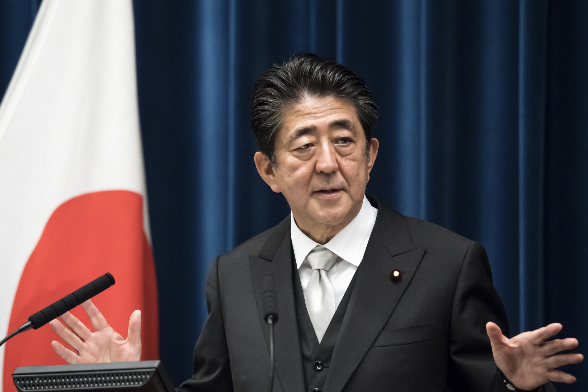 Prime Minister Shinzo Abe speaks during a news conference at his official residence in Tokyo on Wednesday after reshuffling his Cabinet. | BLOOMBERG