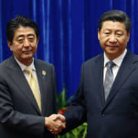 Prime Minister Shinzo Abe and Chinese leader Xi Jinping shake hands during their meeting at the Great Hall of the People, on the sidelines of the Asia-Pacific Economic Cooperation summit, in Beijing on Nov. 10, 2014. The uneasy handshake marked the first meeting between the two men since either took power, and an awkward first gesture toward easing two years of high tensions. | AP