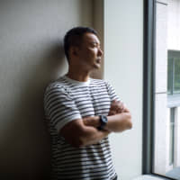 Taro Yamamoto poses for a photograph in Tokyo. Yamamoto says the effect of hiking the sales tax to an easily calculated round number will be to prompt consumers to hold back spending. | BLOOMBERG