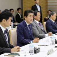 Prime Minister Shinzo Abe addresses a meeting on the future of Japan\'s social security at the Prime Minister\'s Office in Tokyo on Friday. | KYODO