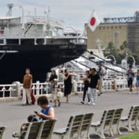 Visitors stroll through Yamashita Park, where the Hikawamaru is anchored, in Yokohama on Aug. 31. | YOSHIAKI MIURA
