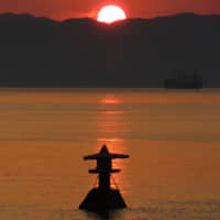 Stone on the water: A stone lantern appears to float of Shiraishi Island in the Seto Inland Sea during half-tide at sunset. | AMY CHAVEZ