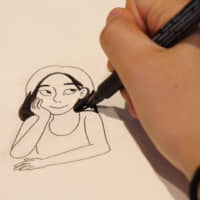This is me: Christine Mari Inzer sketches a self-portrait at the offices of The Japan Times. | CHISATO TANAKA