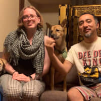 Our house: Rebecca and Hiroaki Takeuchi  pose with their dogs McCoy (left) and Xen (center). | COURTESY OF THE TAKEUCHI FAMILY
