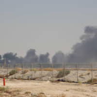 Smoke billows from an Aramco oil facility in Abqaiq, Saudi Arabia, on Saturday. | AFP-JIJI
