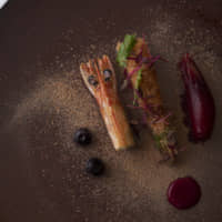 From tip to tail: Dried sakura-ebi shrimp atop a barely cooked shrimp tail and blueberry pickles | COURTESY OF COOK JAPAN PROJECT