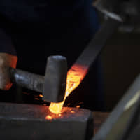 Establishing a rhythm: One of the characteristic Echizen ways of forming a sickle blade is called maikozuchi (dancing mallet) because of the way the mallet is wielded to shape the arc of the blade. | REUTERS