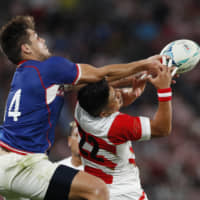 Japan\'s Rikiya Matsuda (right) and Russia\'s German Davydov battle for the ball on Friday. | REUTERS