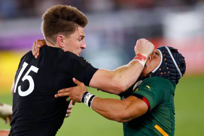 New Zealand's Beauden Barrett (left) attempts to run past South Africa's Cheslin Kolbe in the teams' Rugby World Cup opener on Saturday. | AFP-JIJI