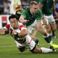 Japan’s Kenki Fukuoka scores a try against Ireland on Saturday. | AP