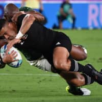 New Zealand flyhalf Richie Mo\'unga is tackled by South Africa wing Makazole Mapimpi during their Rugby World Cup contest on Saturday in Yokohama. | AFP-JIJI