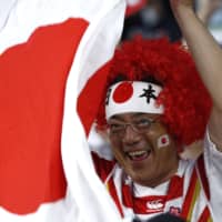 A fan cheers for the Brave Blossoms during Saturday\'s match. | REUTERS