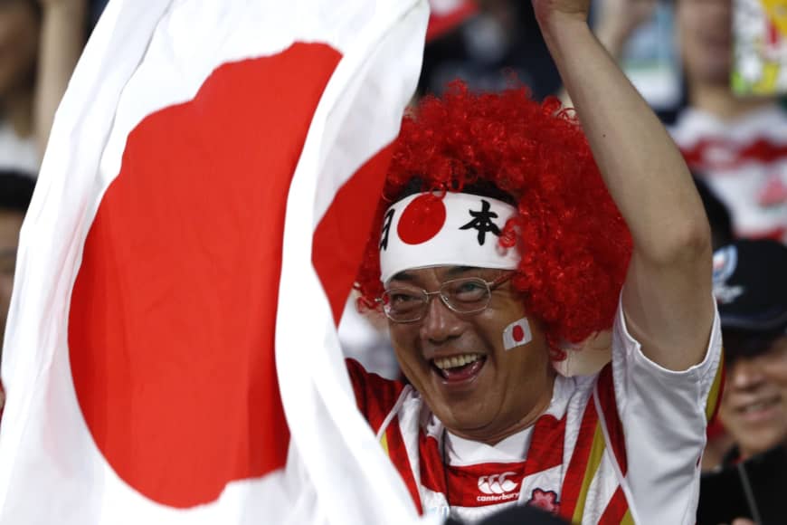 A fan cheers for the Brave Blossoms during Saturday's match. | REUTERS