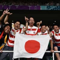 Japan supporters celebrate after the Brave Blossoms defeat Ireland. | AFP-JIJI