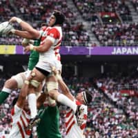 Japan’s lock James Moore jumps for the ball in a lineout. | AFP-JIJI