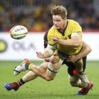 The Wallabies\' Michael Hooper is tackled during a Rugby Championship test match against the All Blacks on Aug. 10 in Perth, Australia. | GETTY IMAGES / VIA KYODO