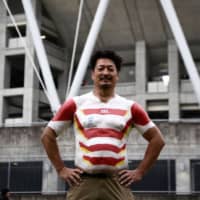 Hiroshi Moriyama poses Saturday outside Shizuoka Stadium Ecopa on the evening of the Japan vs Ireland Pool A game of the 2019 Rugby World Cup. | AFP-JIJI