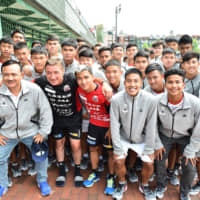 Consadole Sapporo manager Mihailo Petrovic and midfielder Chanathip Songkrasin pose with visiting Thai players in August at the team\'s training ground in Sapporo. | COURTESY OF J. LEAGUE