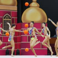 Japan\'s rhythmic gymnastics team performs in the group five-balls category at the world championships in Baku on Sunday. The team, known as \'Fairy Japan,\' took first for the country\'s first-ever gold medal in the competition. | KYODO