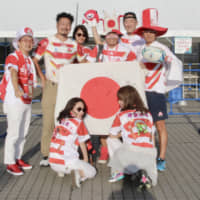 Hiroshi Moriyama (back row, second from left) and his friends pose for a photo before Friday\'s Rugby World Cup opener between Japan and Russia at Tokyo Stadium. | KAZ NAGATSUKA